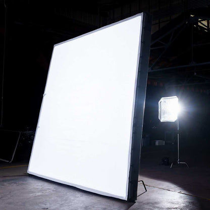12x12 Butterfly Frame Photography Softbox illuminated in a studio setup, showcasing its large surface for soft light diffusion in professional shoots.